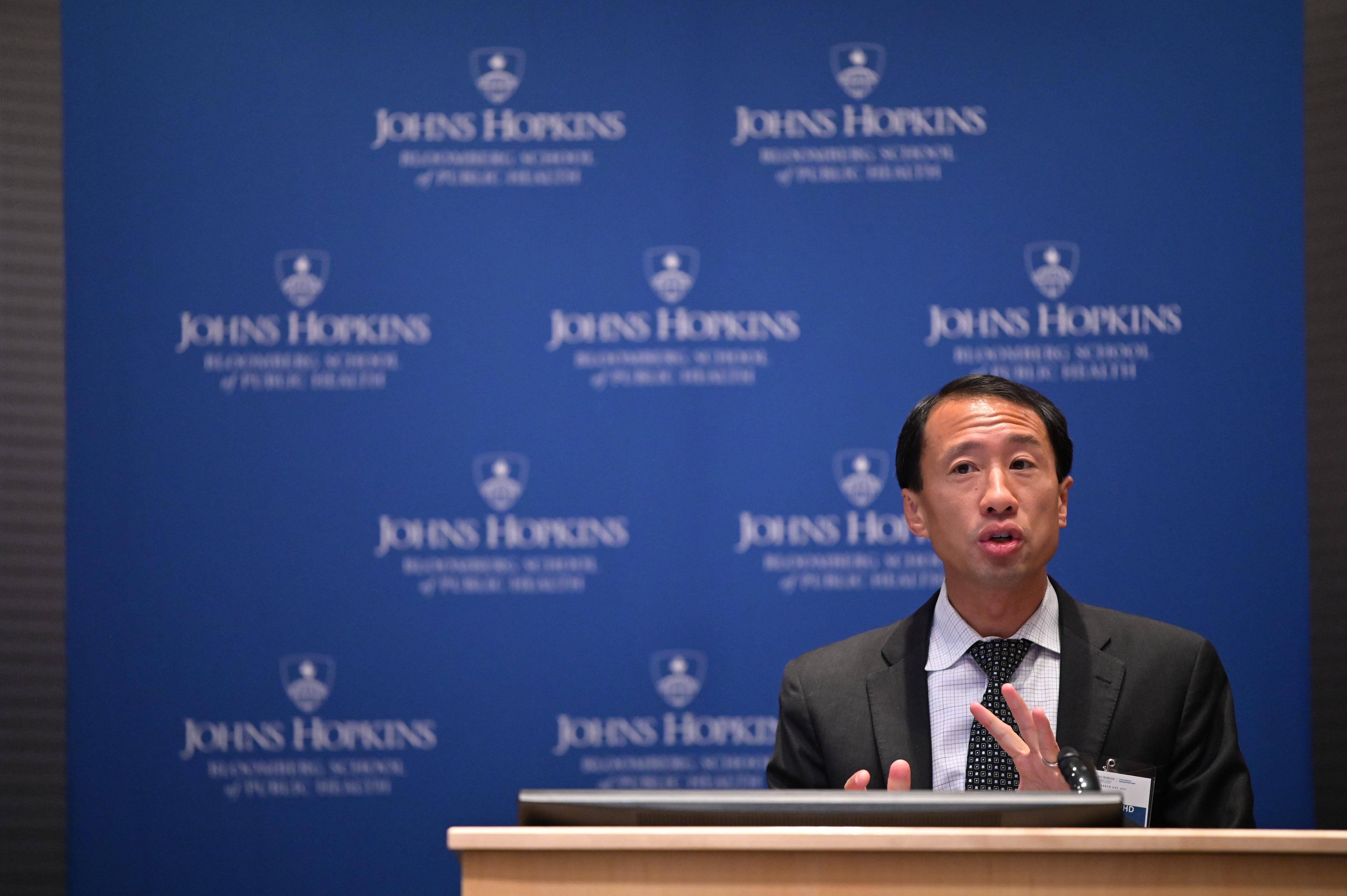 Researcher Frank Lin presenting at a podium